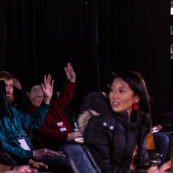 Audience members raising hands