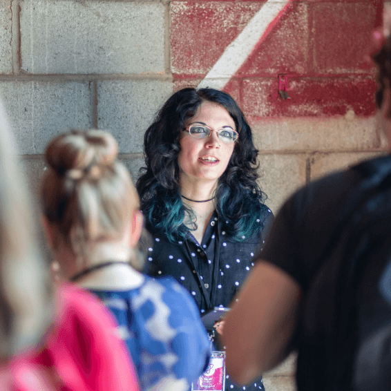 Speaker talking with attendees at FusionConf